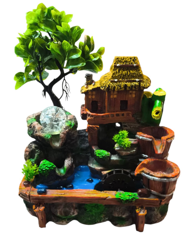 Decorative miniature garden with a small house, tree, and water features on a white background